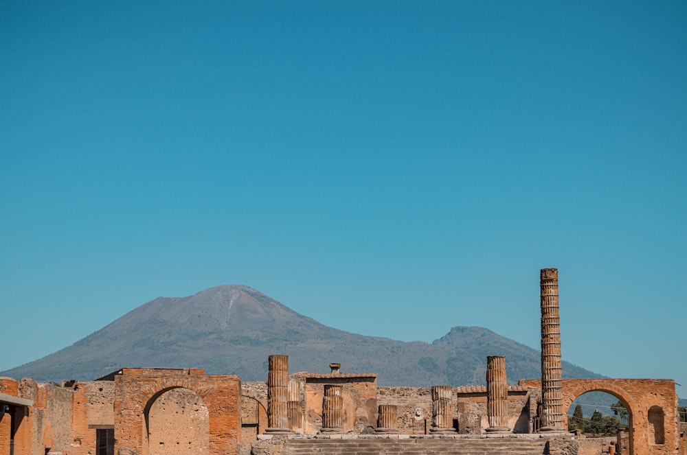 the ruins of a roman city with a mountain in the background