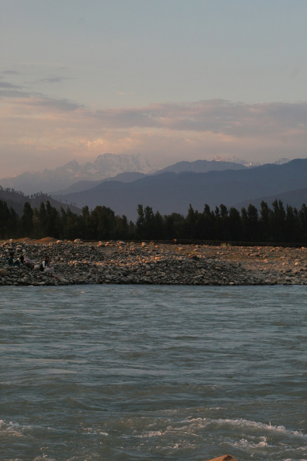 a body of water with mountains in the background