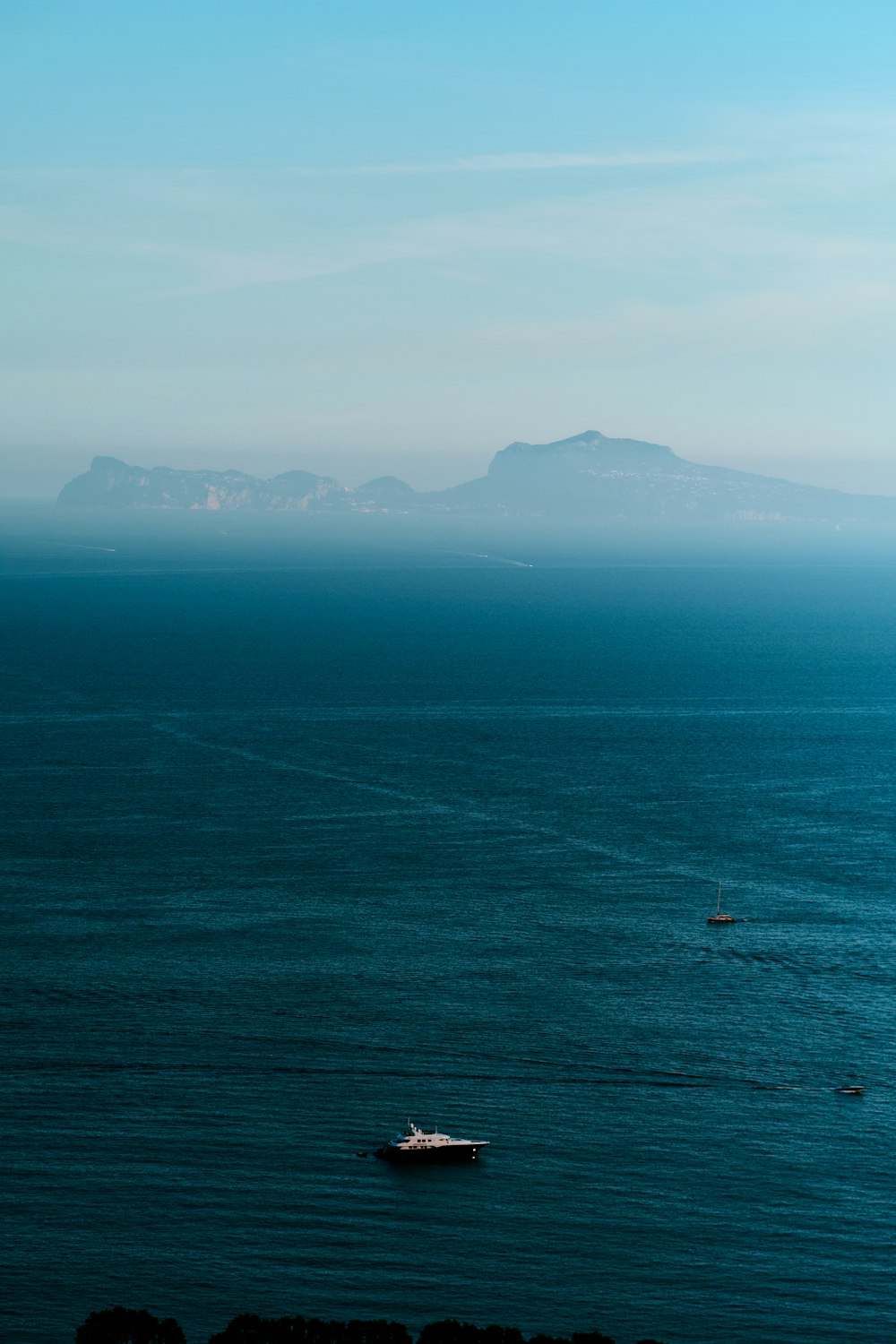 a boat floating in the middle of a large body of water