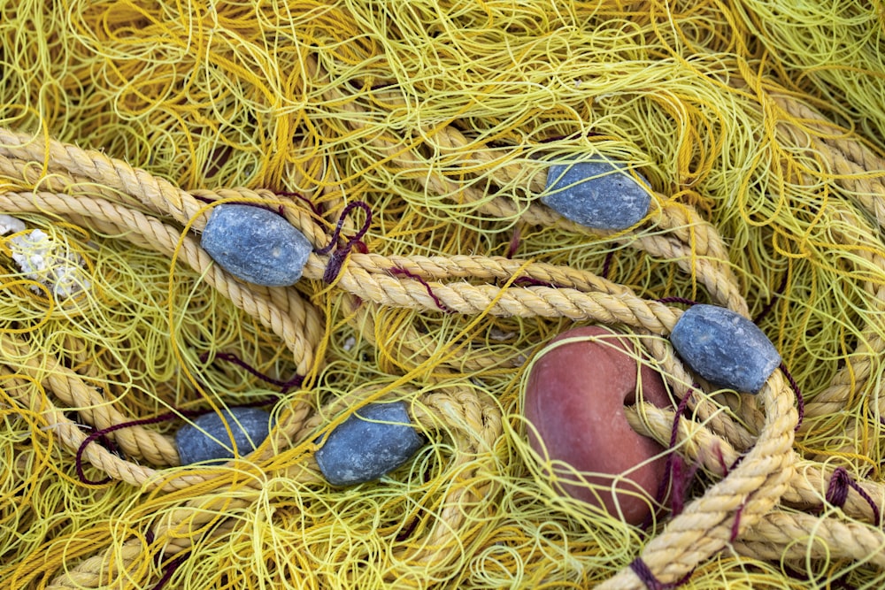 a pile of yellow and blue fishing nets