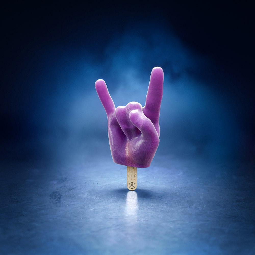 a purple peace sign on a wooden stick