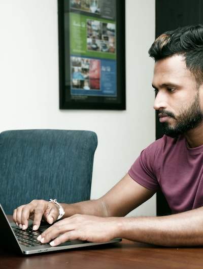 a man sitting in front of a laptop computer