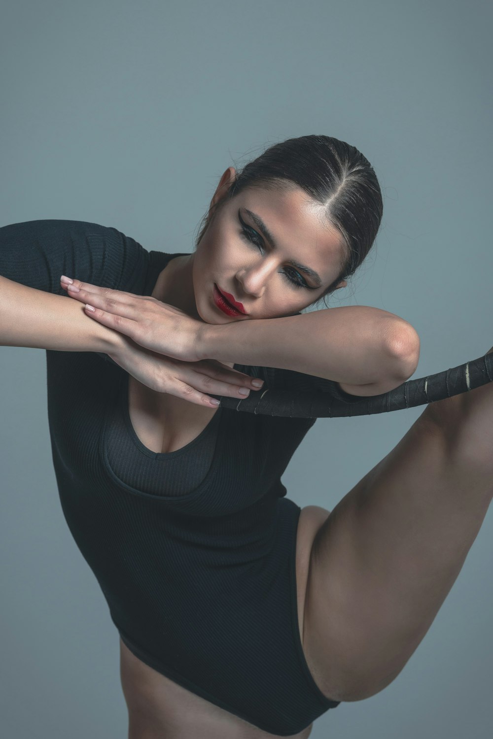 a woman is posing with her arms crossed