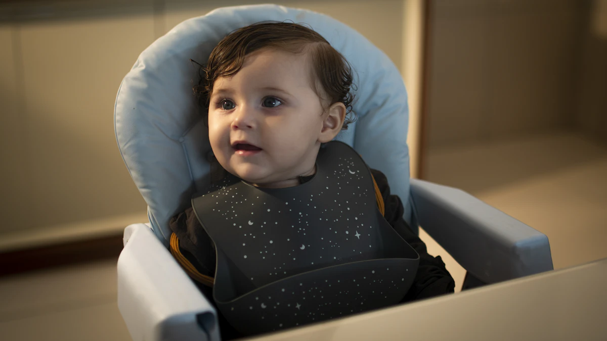 Baby sitting in a high chair with a soft, padded fabric-cushioned seat back