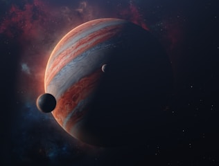 A large gas giant planet with swirling, colorful bands is prominently displayed, partially shadowed, with two smaller celestial bodies nearby. The background consists of a starry sky with nebula-like clouds.