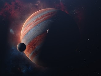 A large gas giant planet with swirling, colorful bands is prominently displayed, partially shadowed, with two smaller celestial bodies nearby. The background consists of a starry sky with nebula-like clouds.