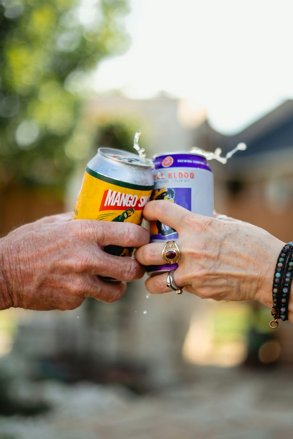 a man and a woman exchanging a can of beer