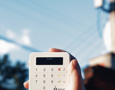 a person holding a calculator in their hand