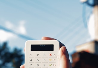 a person holding a calculator in their hand