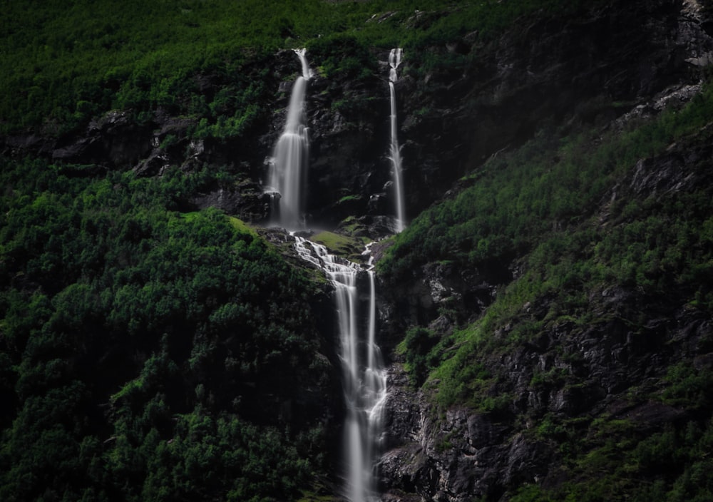 a tall waterfall with a waterfall running down it's side