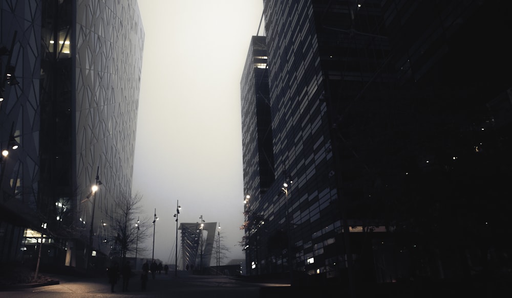 a city street at night with tall buildings