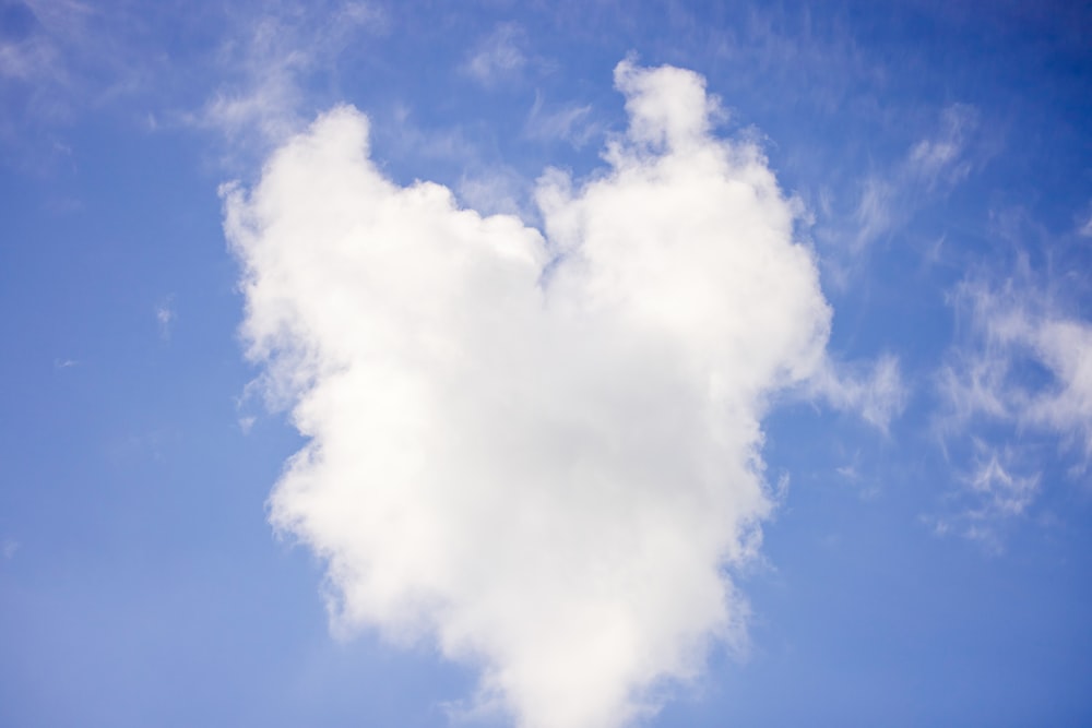 a heart shaped cloud in a blue sky