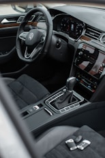the interior of a car with a steering wheel and dashboard
