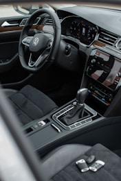 the interior of a car with a steering wheel and dashboard