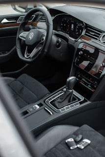 the interior of a car with a steering wheel and dashboard
