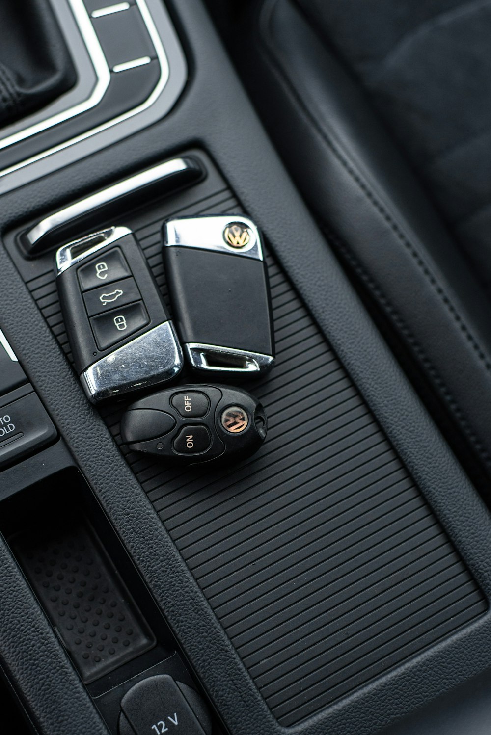 a bunch of car keys sitting on the center console of a car