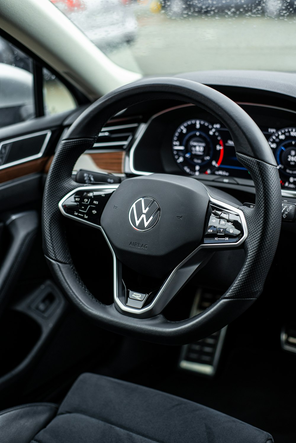 a car dashboard with a steering wheel and dashboard lights