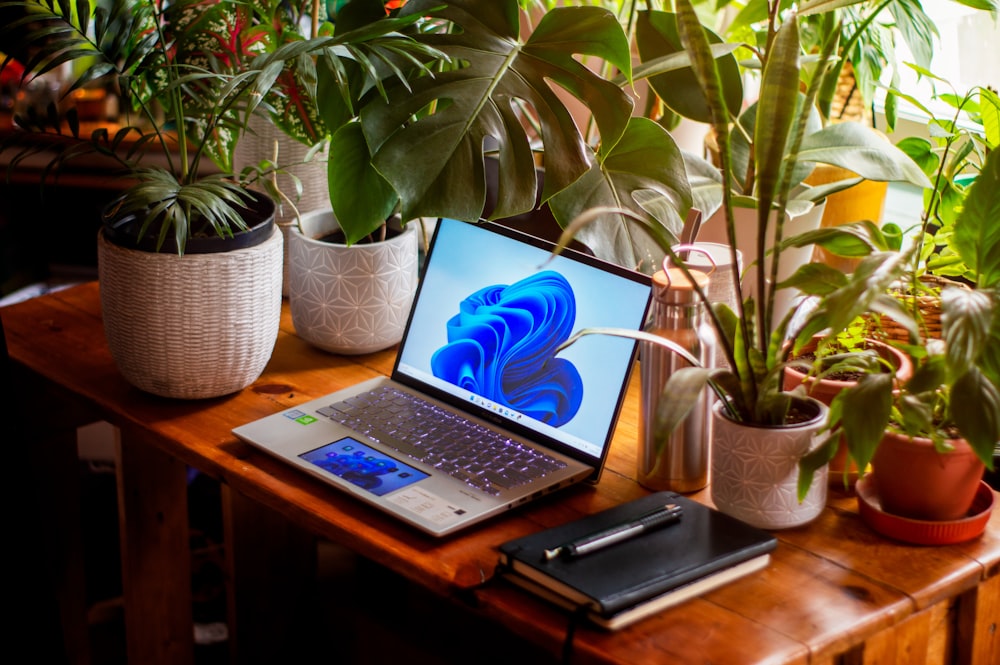 a laptop computer sitting on top of a wooden table