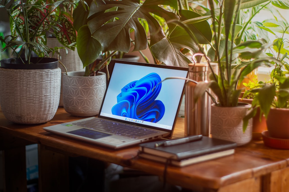 a laptop computer sitting on top of a wooden desk