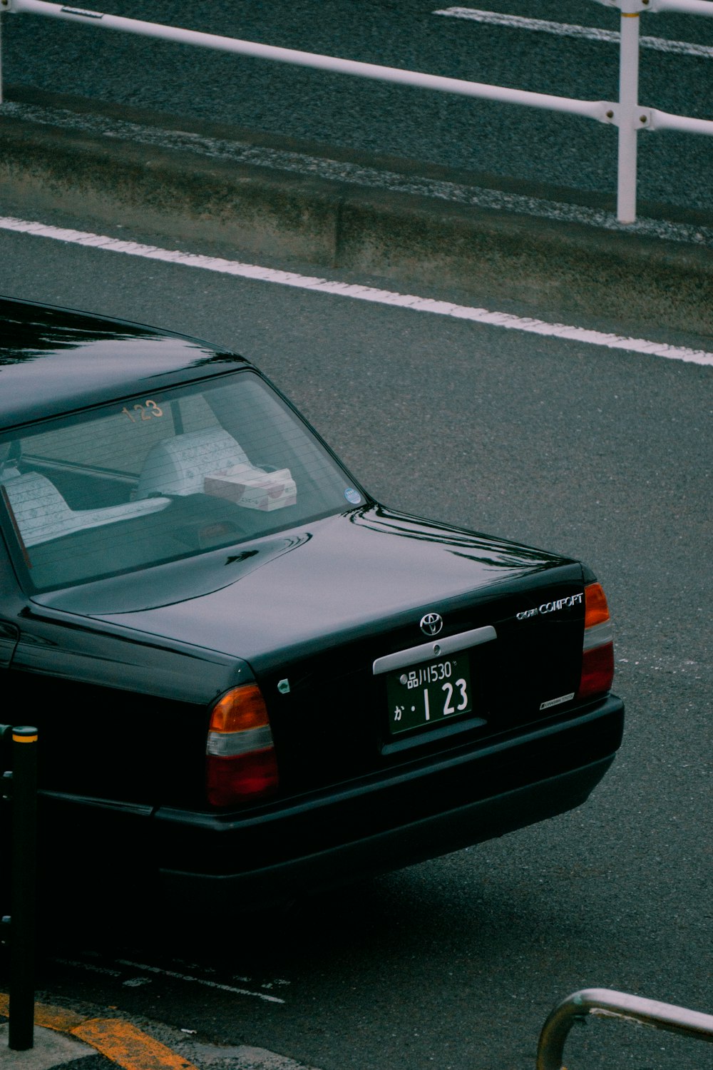 a black car parked on the side of the road