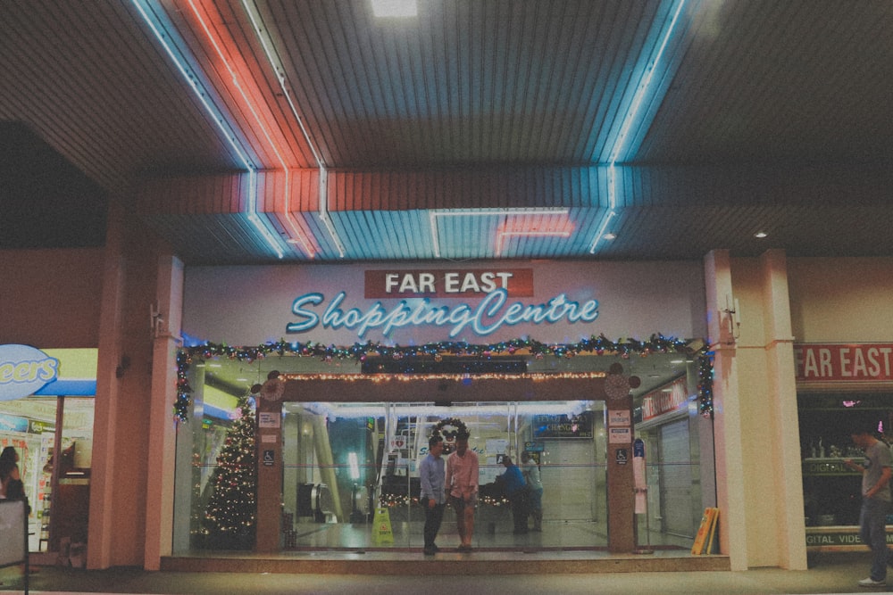 a store front with people walking in front of it