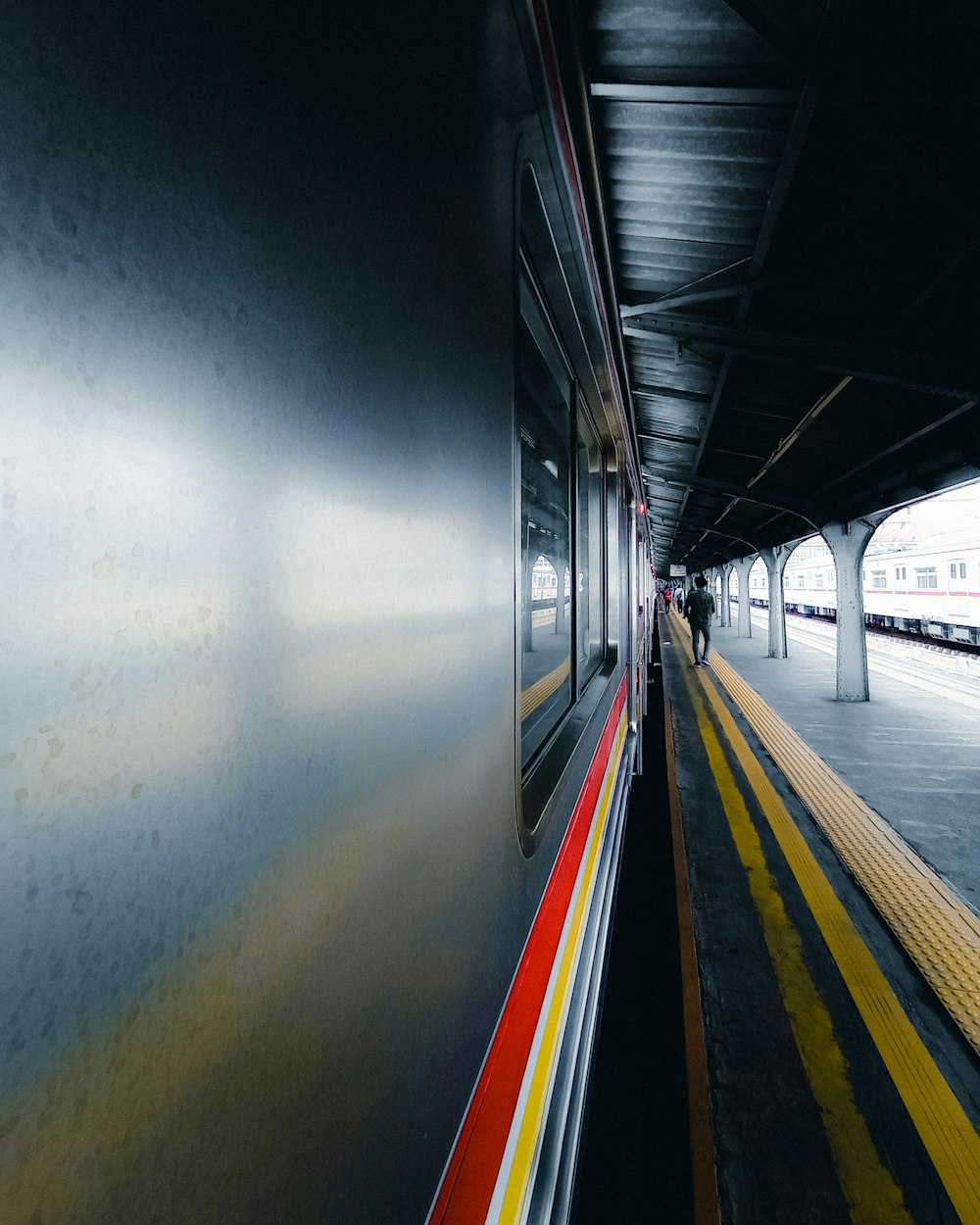 a train pulling into a train station next to a platform