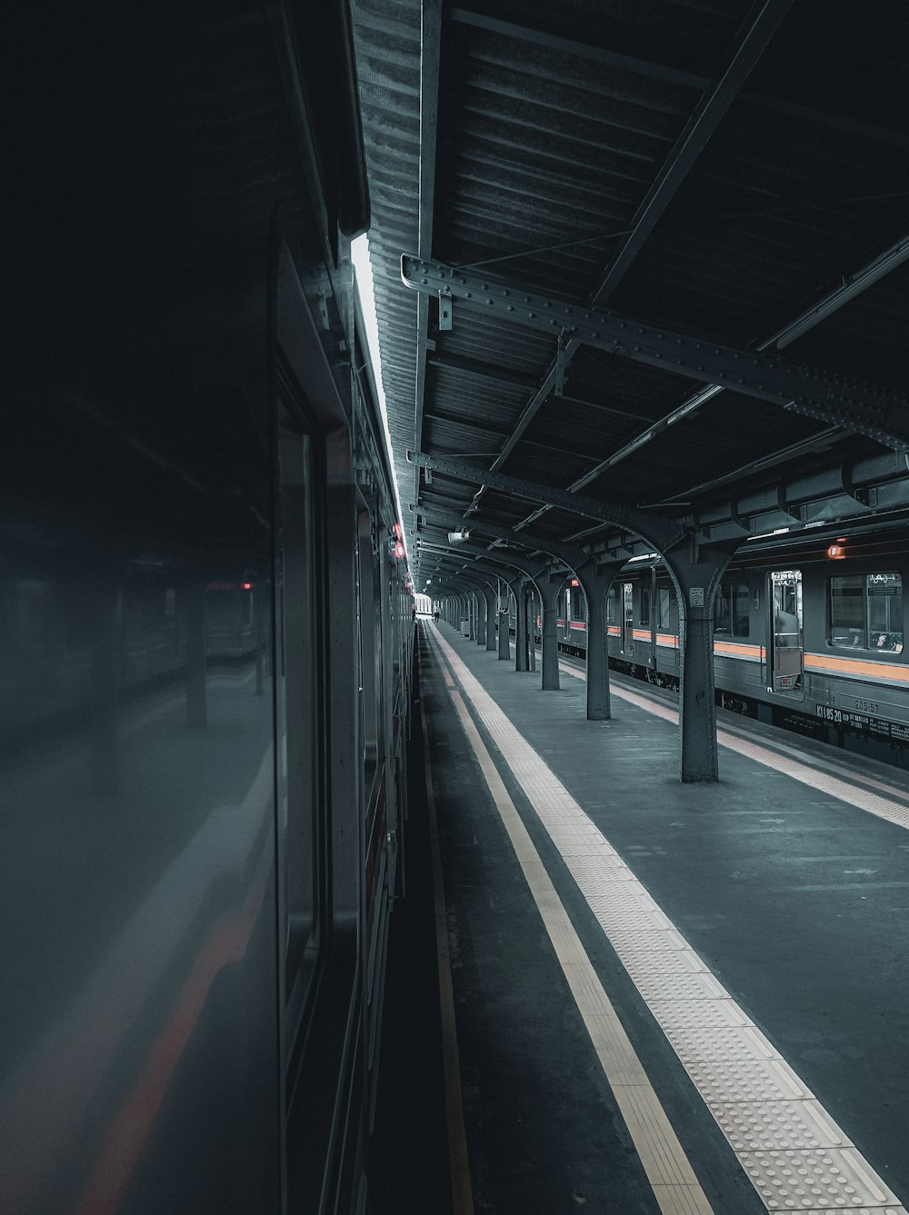 a train pulling into a train station next to a platform