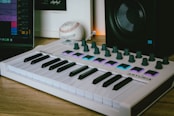 a musical keyboard sitting on top of a wooden table