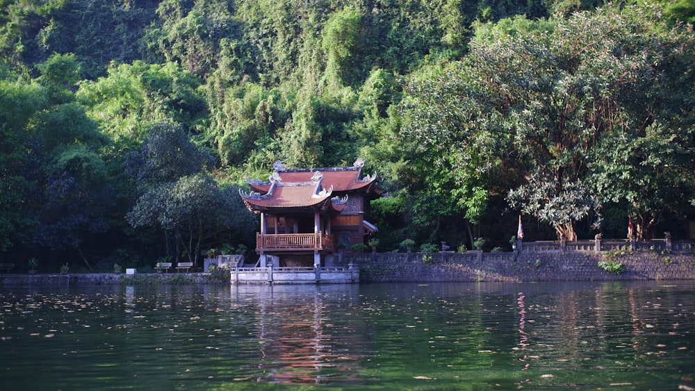 a small house sitting on top of a body of water