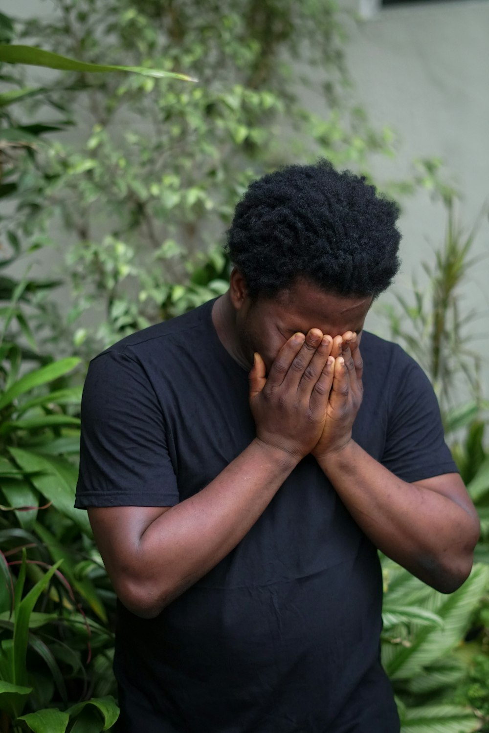 a man covers his face with his hands