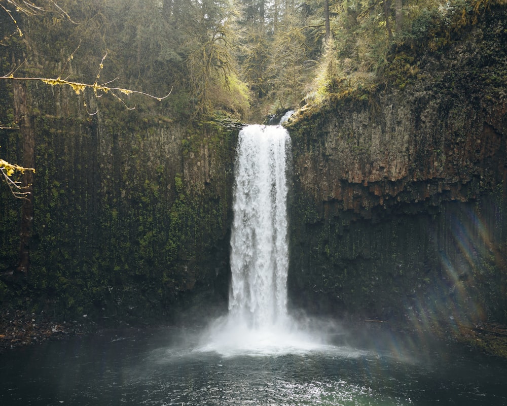 a waterfall in the middle of a body of water