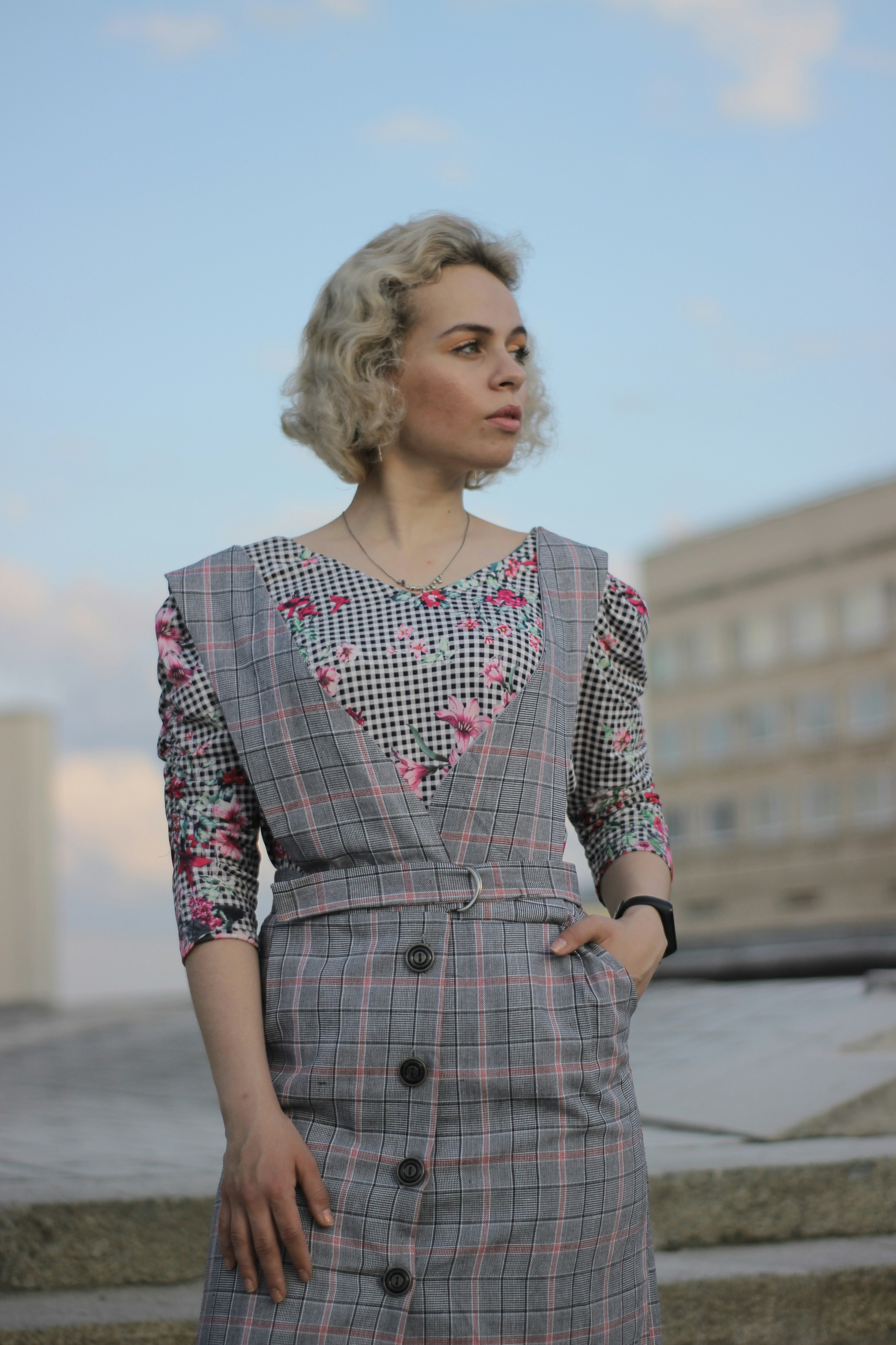a woman in a dress standing on some steps