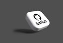a white dice with a black github logo on it