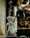 Hands gently pouring hot water over a V60 dripper with fresh coffee grounds.