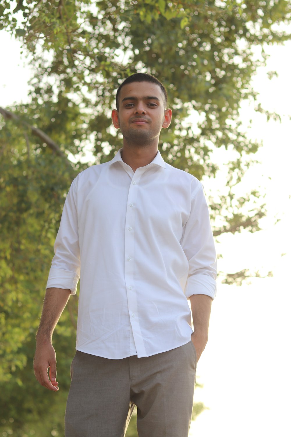 a man standing in front of a tree