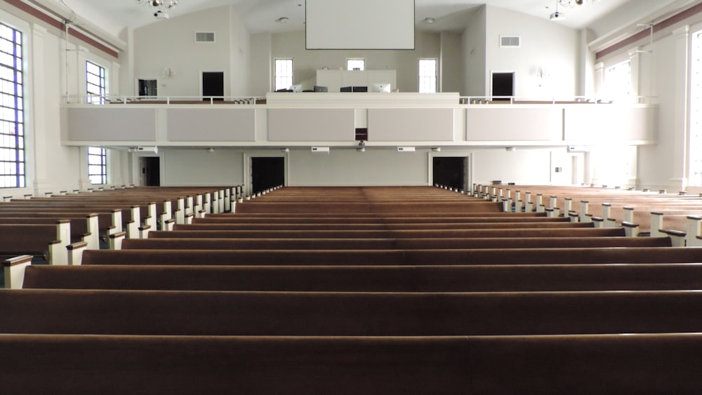 a church with rows of pews and a large mirror