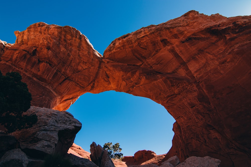 a large rock formation with a blue sky in the background