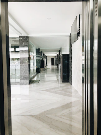 Pristine hotel corridor with polished surfaces and ambient lighting