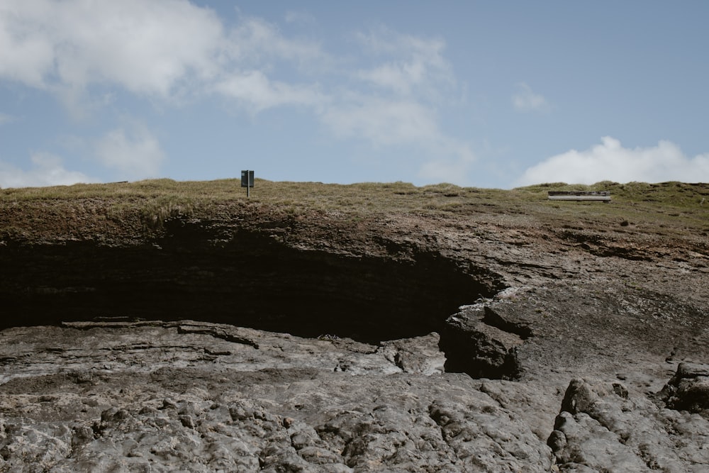 a person standing on top of a rocky hill