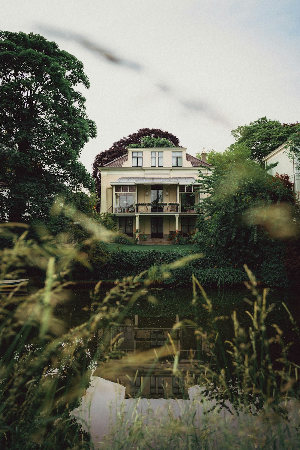 a house sitting on top of a lush green field