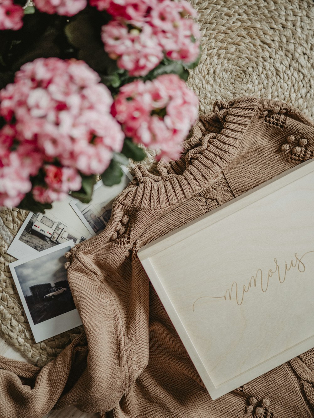 a bouquet of pink flowers sitting next to a book