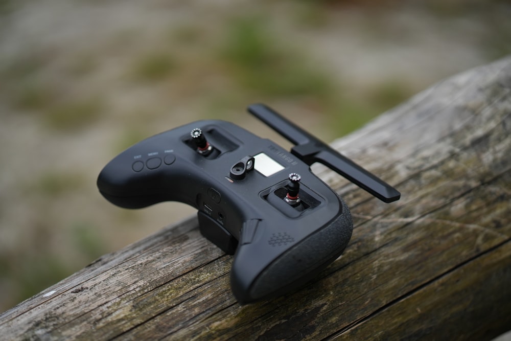 a video game controller sitting on top of a wooden table