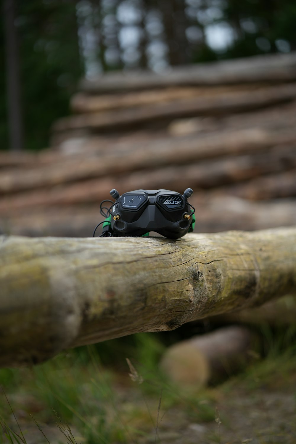 a camera sitting on top of a wooden log