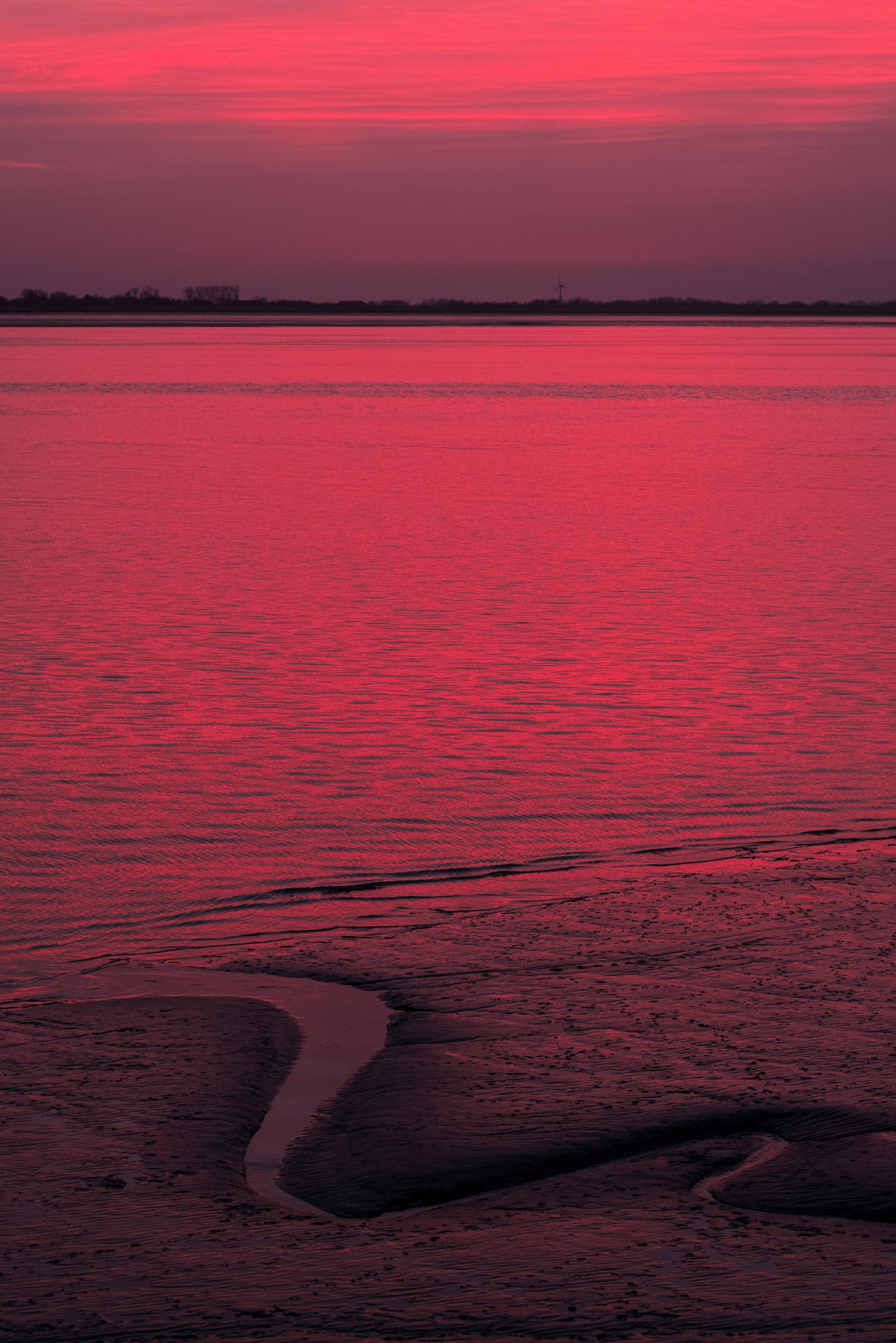 a red sunset over a body of water