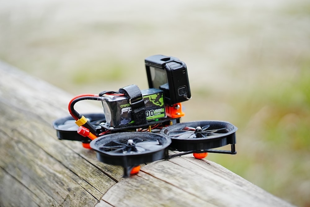 a camera sitting on top of a piece of wood