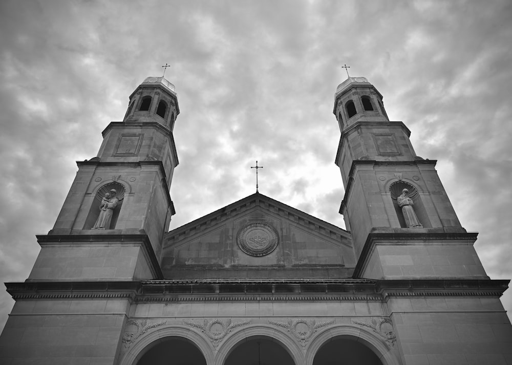 a black and white photo of a church with two towers