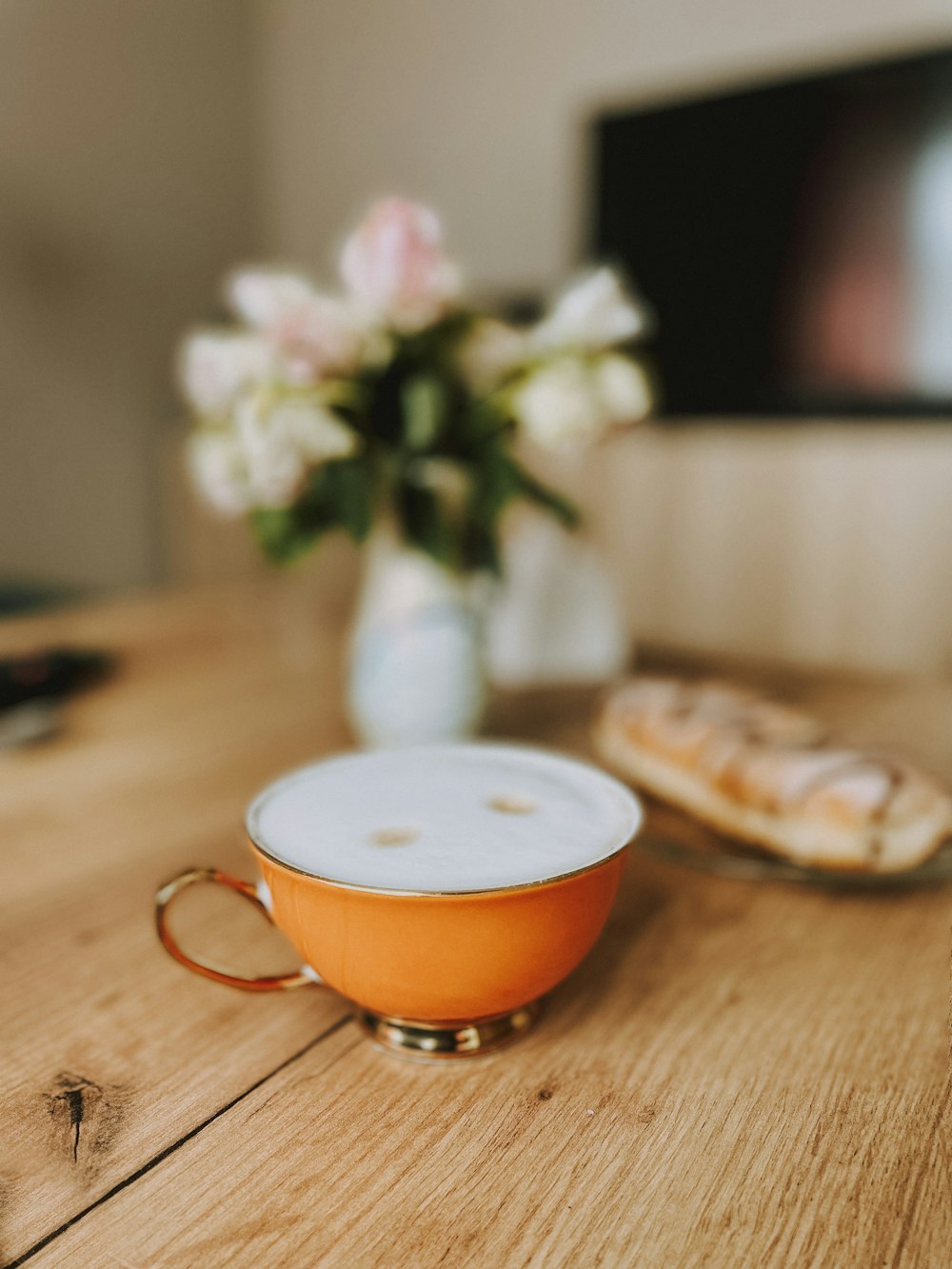 a cup and saucer sitting on a wooden table