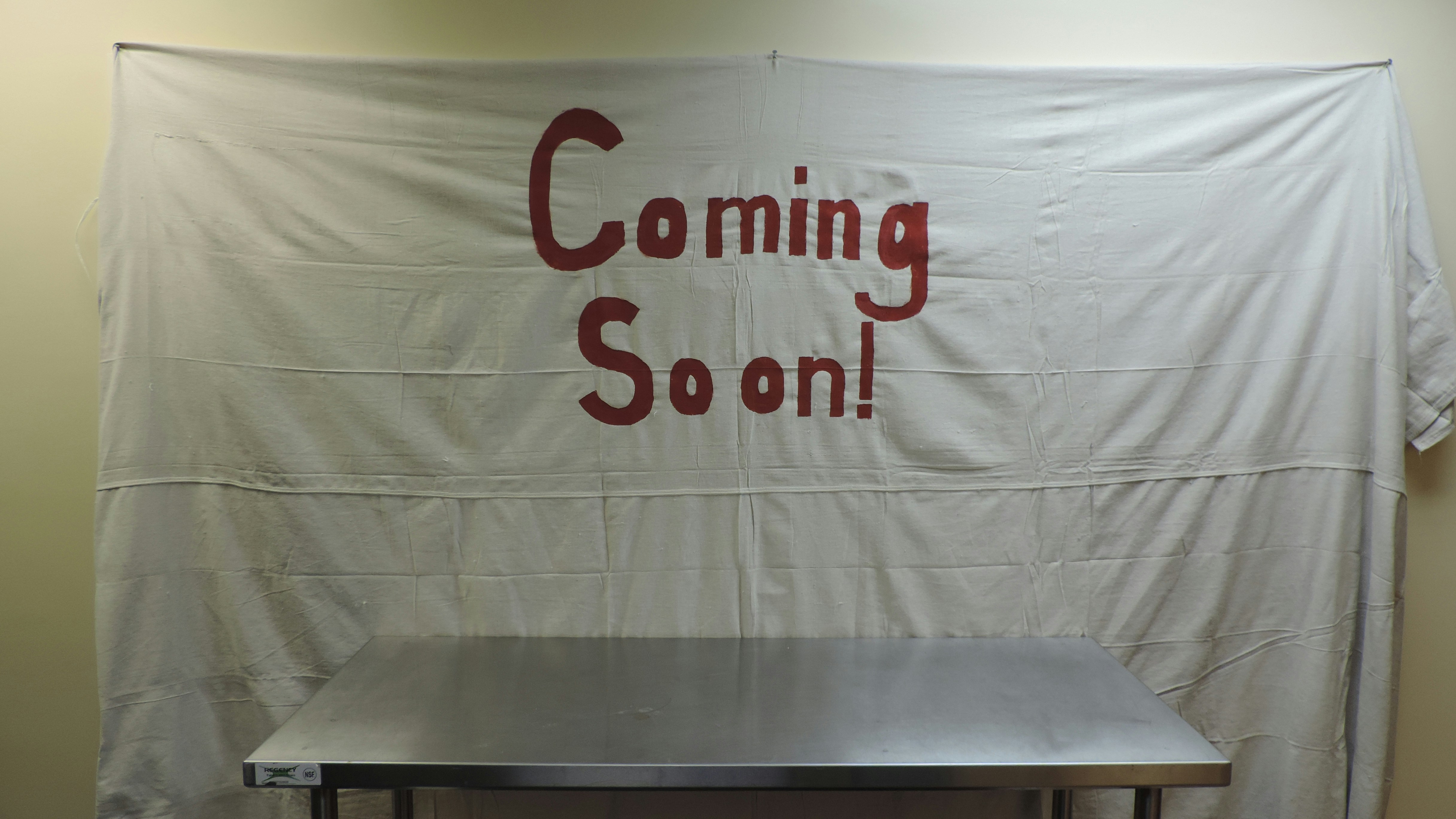 A table with a sign that says coming soon