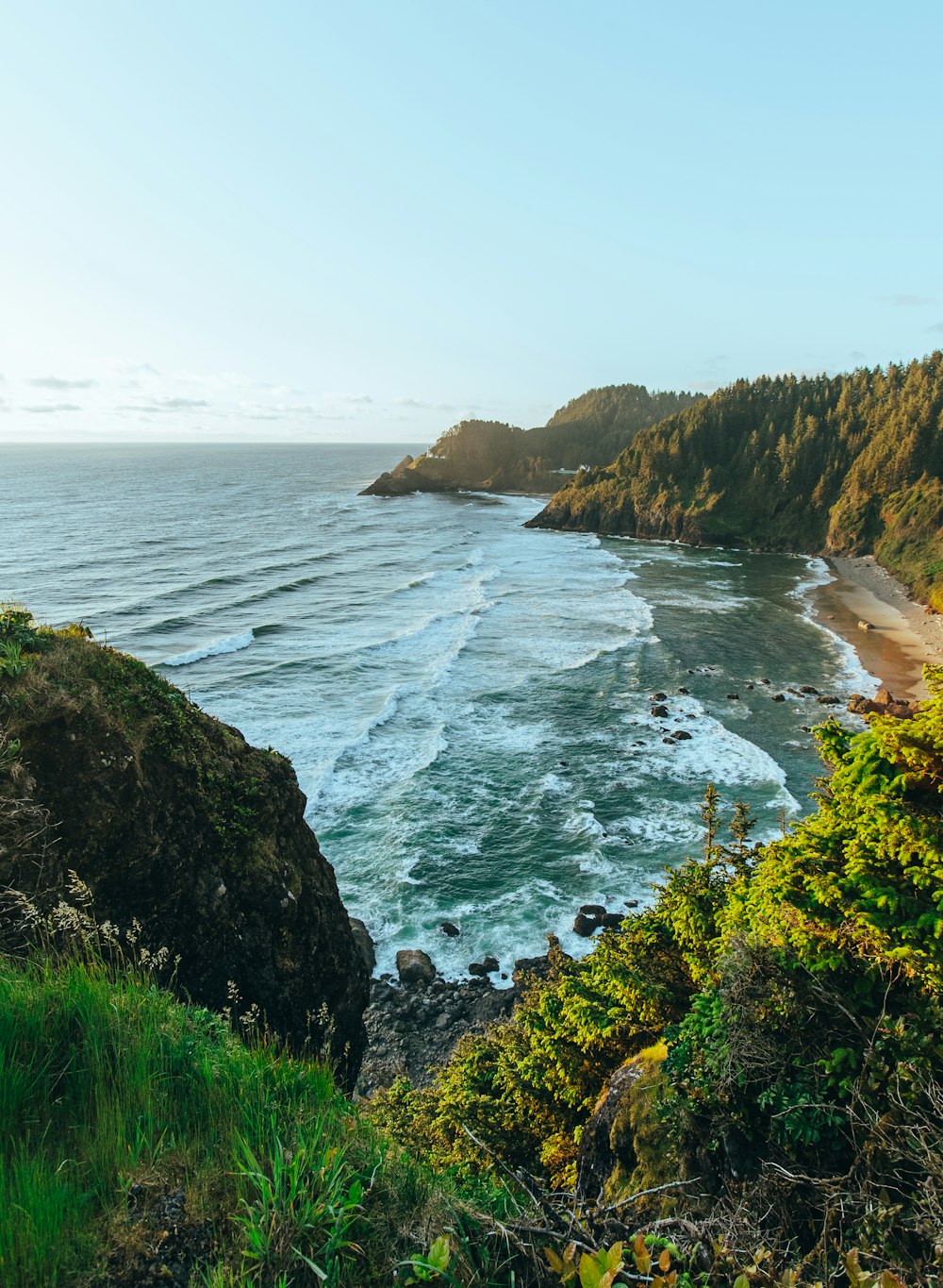 a view of the ocean from the top of a hill