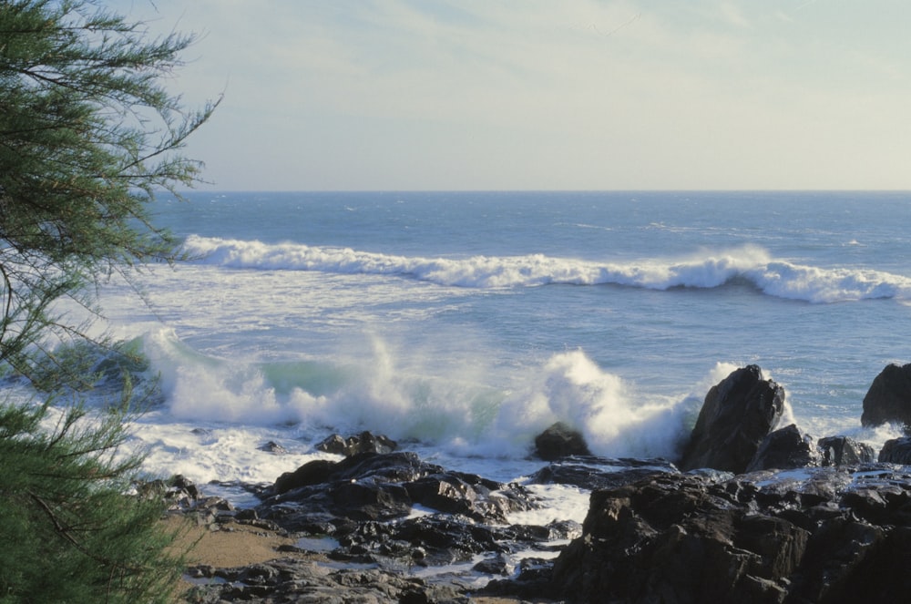 a view of the ocean from a rocky shore